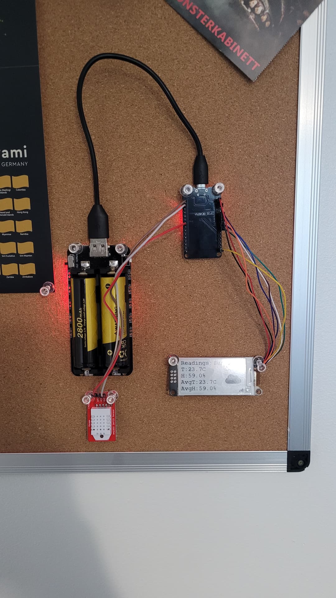The finished ESP32 climate monitor prototype, mounted on a cork board and battery powered.